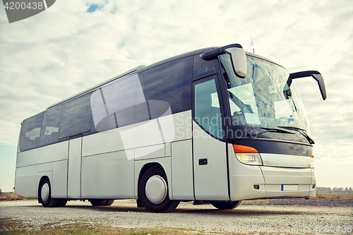 Image of tour bus driving outdoors