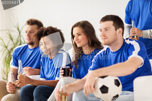 Image of friends or football fans watching soccer at home