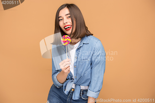 Image of The young woman with colorful lollipop