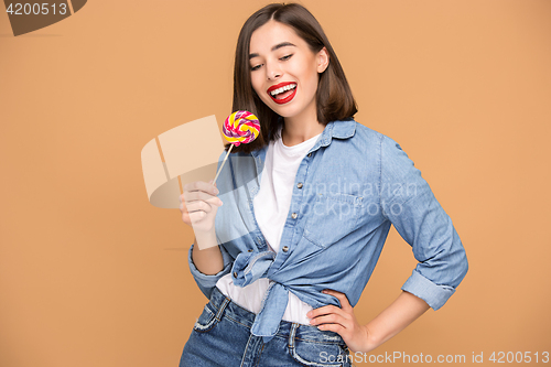 Image of The young woman with colorful lollipop