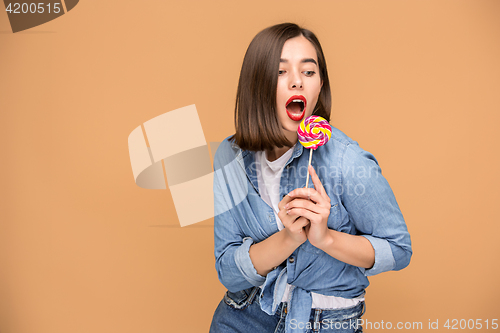 Image of The young woman with colorful lollipop