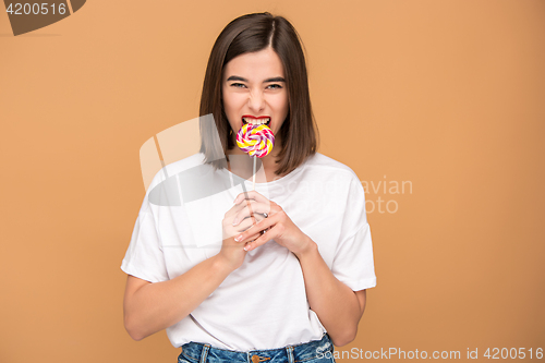 Image of The young woman with colorful lollipop