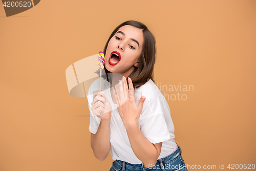 Image of The young woman with colorful lollipop