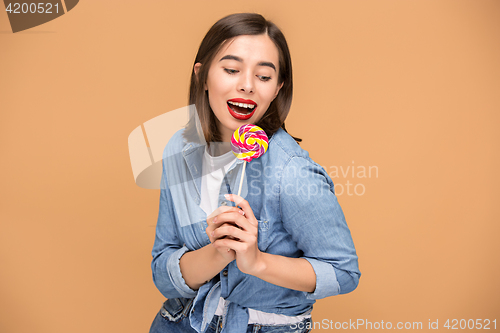 Image of The young woman with colorful lollipop