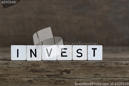 Image of Invest, written in cubes    