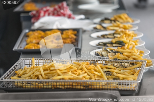Image of French fries and meat on the table