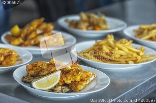 Image of French fries and meat on the table