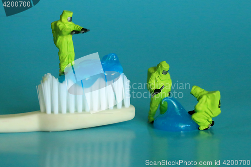 Image of Miniature Workers Performing Dental Procedures. Dental Office Ar