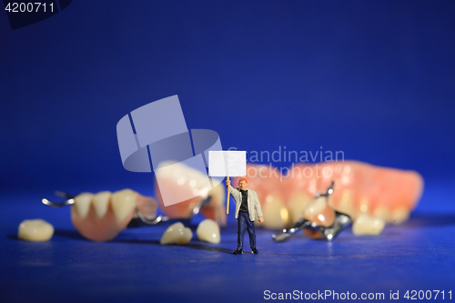 Image of Miniature Workers Performing Dental Procedures. Dental Office Ar