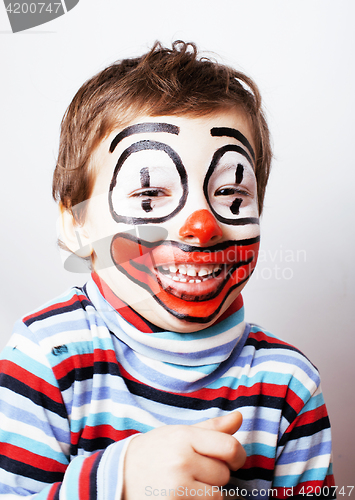 Image of little cute boy with facepaint like clown, pantomimic expression