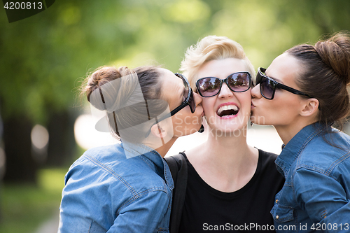 Image of portrait of three young beautiful woman with sunglasses