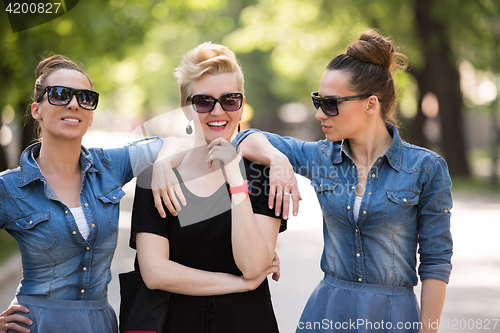 Image of portrait of three young beautiful woman with sunglasses