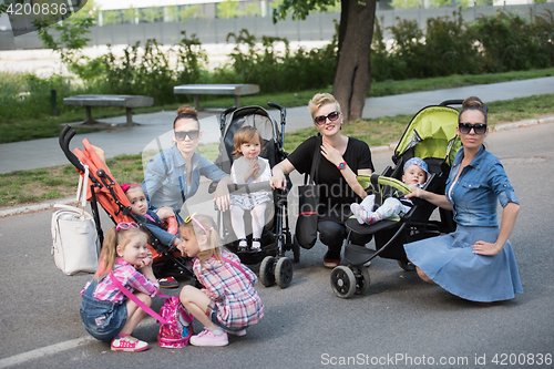 Image of mother with children in the park