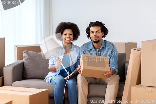 Image of happy couple with stuff moving to new home