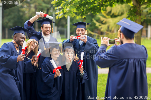 Image of students or bachelors photographing by smartphone