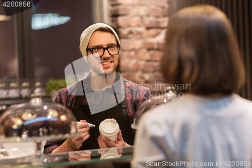 Image of man or barman with coffee cup and customer at cafe