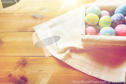 Image of close up of colored easter eggs in basket