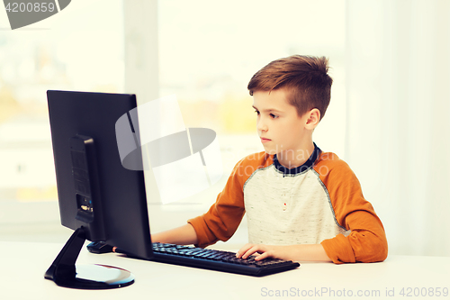 Image of boy with computer at home