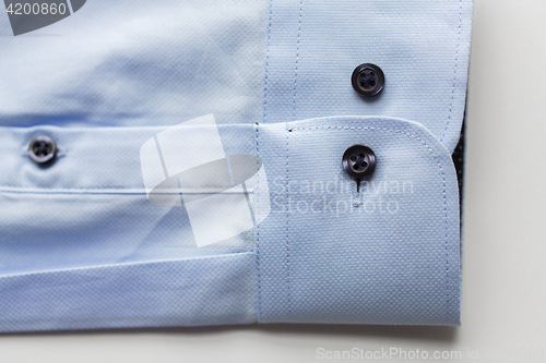 Image of close up of blue shirt sleeve