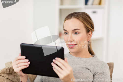 Image of smiling woman with tablet pc at home