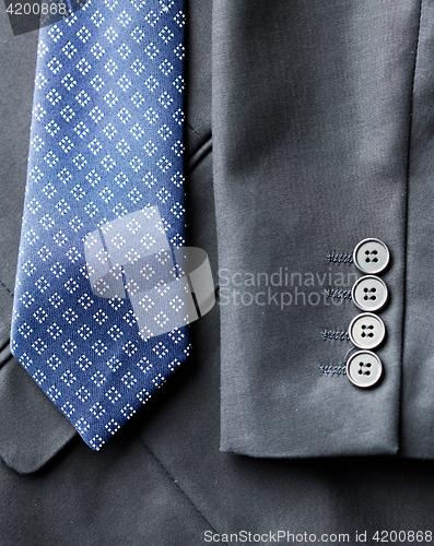 Image of close up of business suit jacket and tie