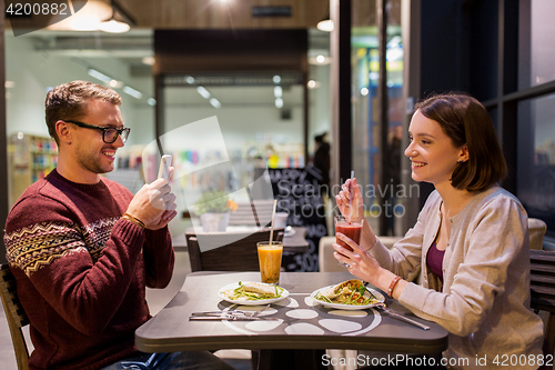 Image of happy couple having dinner at vegan restaurant