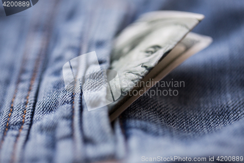 Image of dollar money in pocket of denim jacket