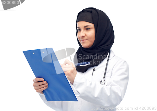 Image of muslim female doctor in hijab with clipboard