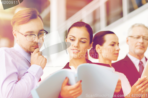 Image of business team with folders meeting at office