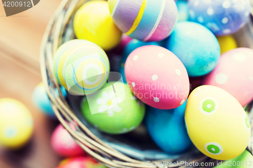 Image of close up of colored easter eggs in basket