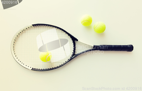 Image of close up of tennis racket with balls