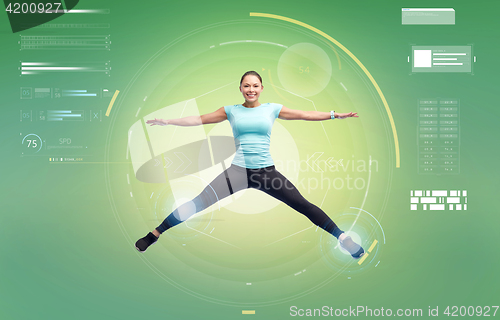 Image of happy smiling sporty young woman jumping in air