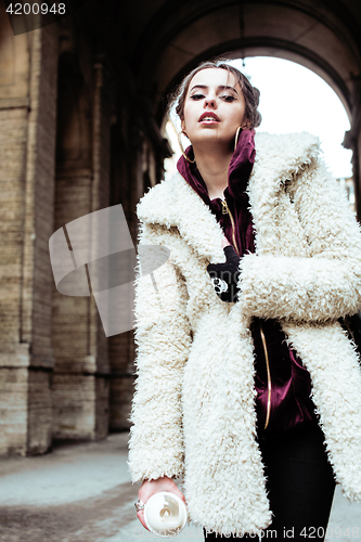 Image of young pretty stylish teenage girl outside on city street fancy f