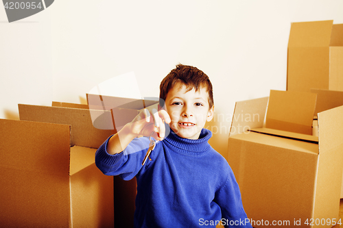 Image of little cute boy in empty room, remoove to new house. home alone, lifestyle people concept