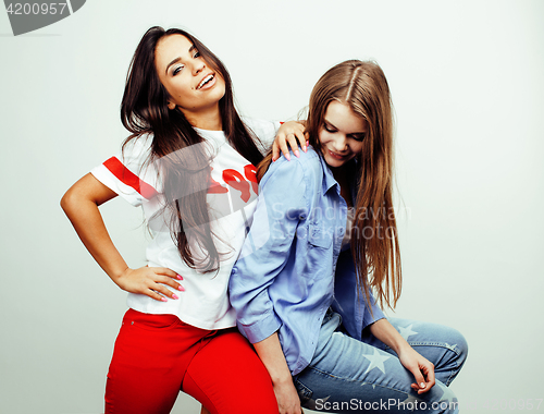 Image of best friends teenage girls together having fun, posing emotional on white background, besties happy smiling, lifestyle people concept, blond and brunette multi nations 