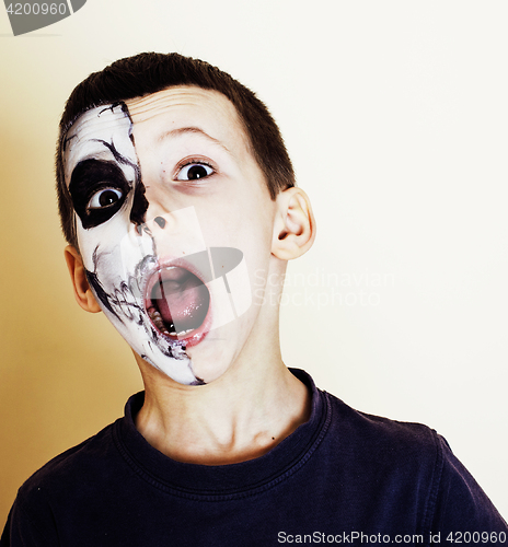 Image of little cute boy with facepaint like skeleton to celebrate hallow