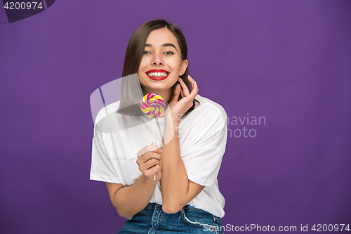 Image of The young woman with colorful lollipop