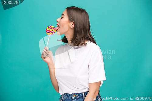 Image of The young woman with colorful lollipop