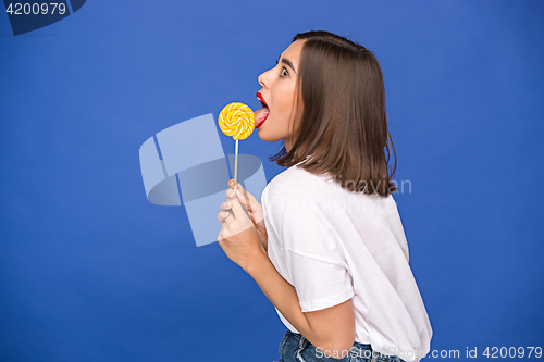 Image of The young woman with colorful lollipop