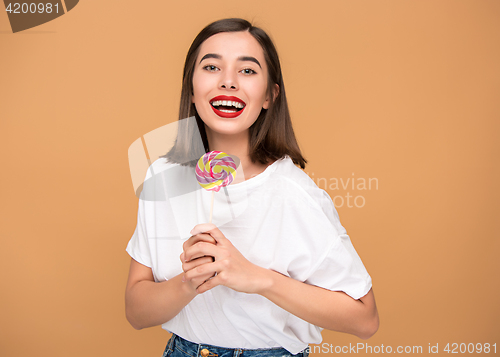 Image of The young woman with colorful lollipop