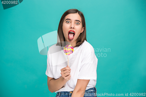 Image of The young woman with colorful lollipop