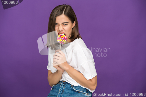 Image of The young woman with colorful lollipop