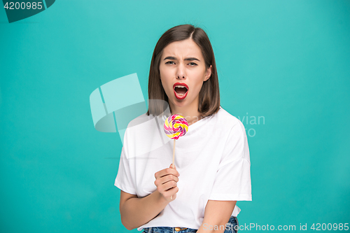 Image of The young woman with colorful lollipop