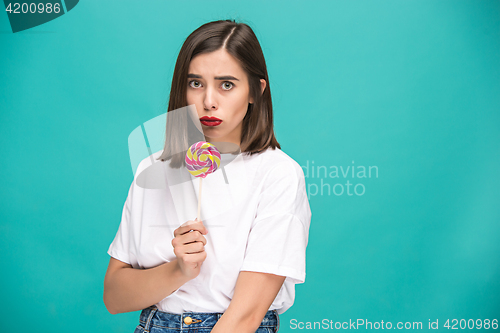 Image of The young woman with colorful lollipop
