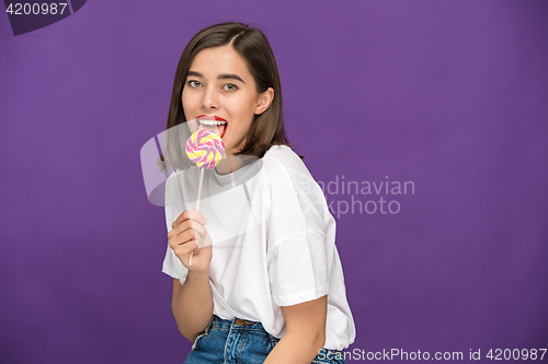 Image of The young woman with colorful lollipop