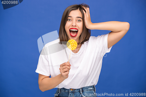 Image of The young woman with colorful lollipop