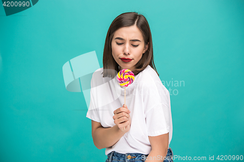 Image of The young woman with colorful lollipop