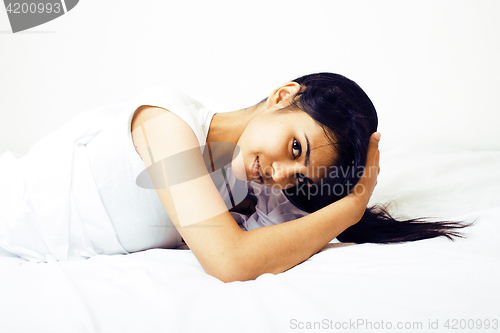 Image of young pretty tann woman in bed among white sheets having fun, tr