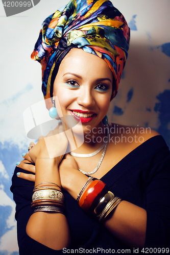 Image of beauty bright african woman with creative make up, shawl on head