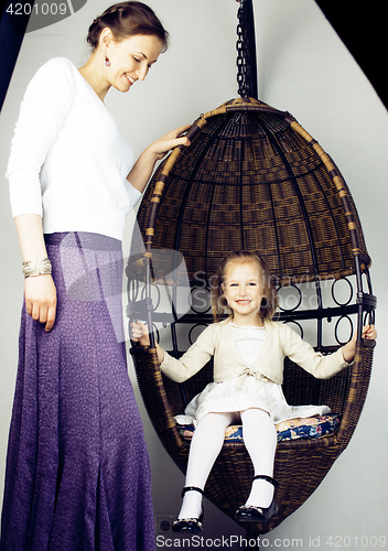 Image of young mother with daughter at luxury home interior vintage